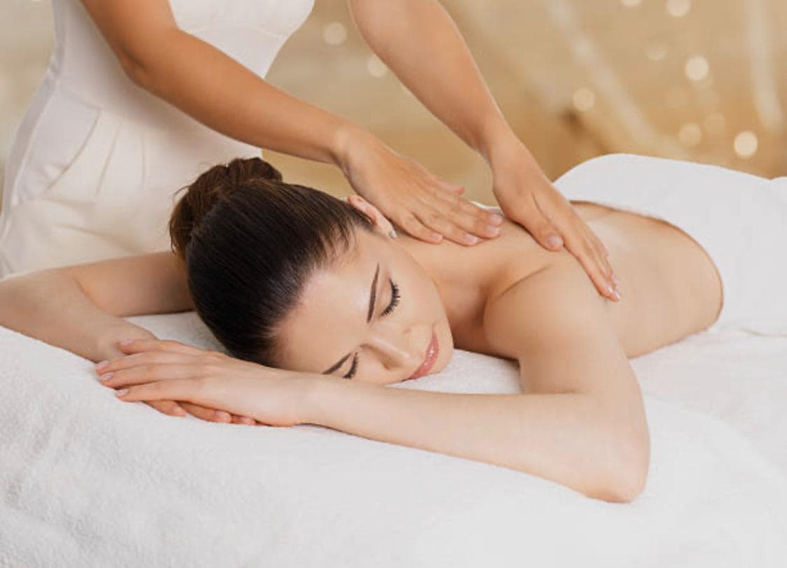 Relaxing back and shoulder massage on a client lying on a treatment bed