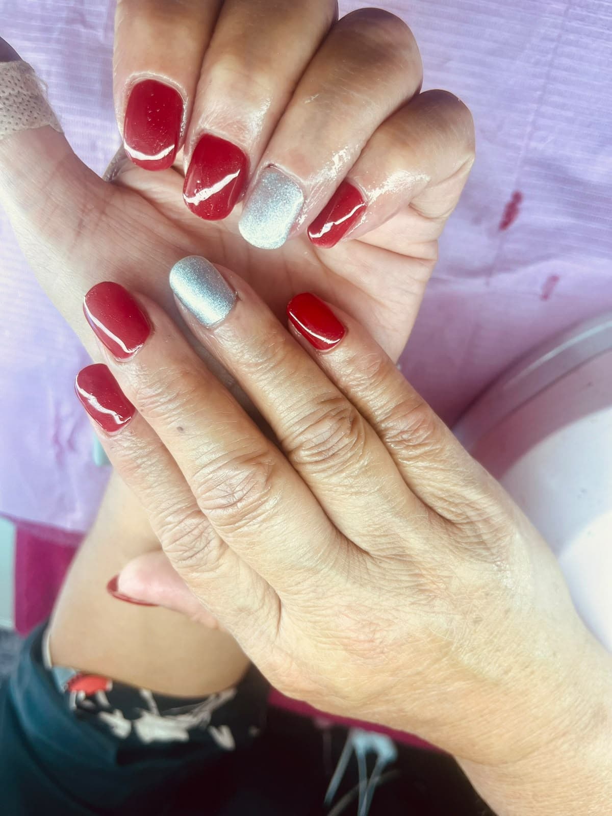 Red gel nails with silver glitter accent nails