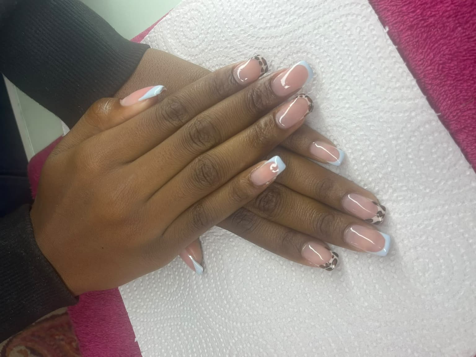 Baby blue French tips and leopard print nail art on long square nails